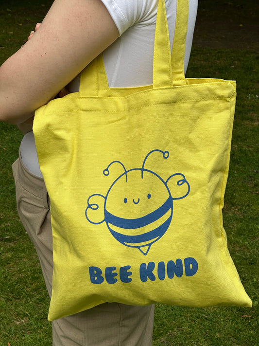 Close-up of blue bee print on yellow cotton tote by Tantrm