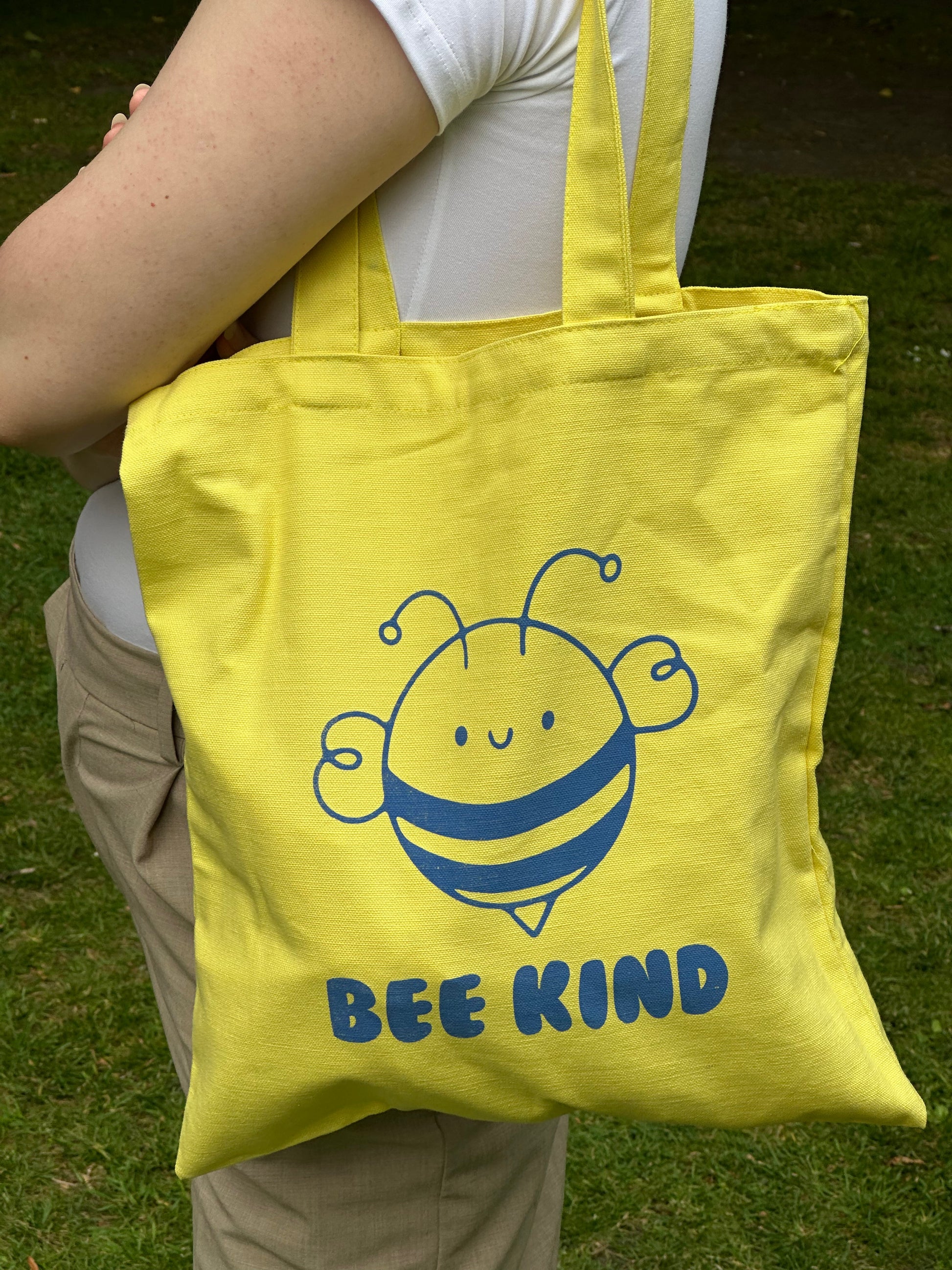 Close-up of blue bee print on yellow cotton tote by Tantrm